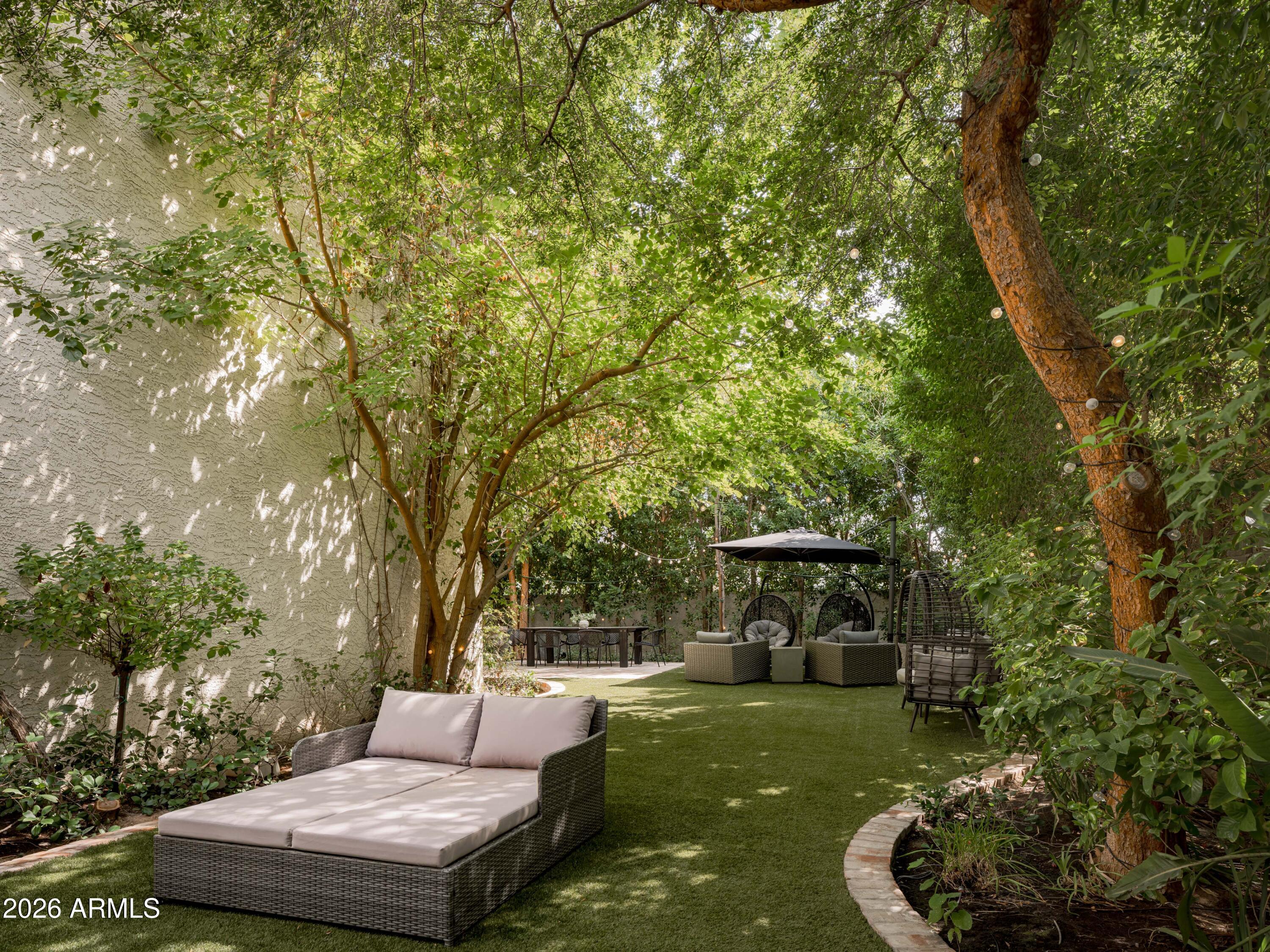 4620 North 40th Street Phoenix, AZ 85018 - Photo 20 of 26 a view of a backyard with couches plants and large trees