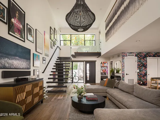 a living room with furniture a fireplace and a large window