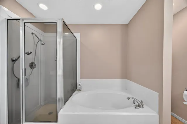 a view of walk in closet with clothes