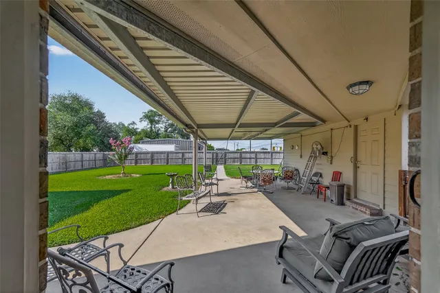 a view of a backyard with plants and a patio