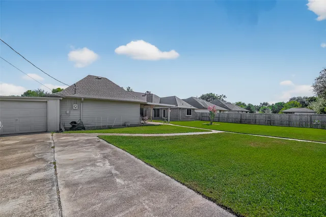 a front view of a house with a yard and potted plants