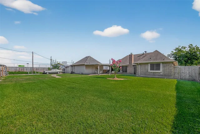 a view of road with grass and a big yard