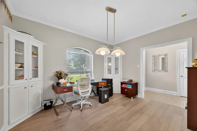 a view of a livingroom with workspace and a window
