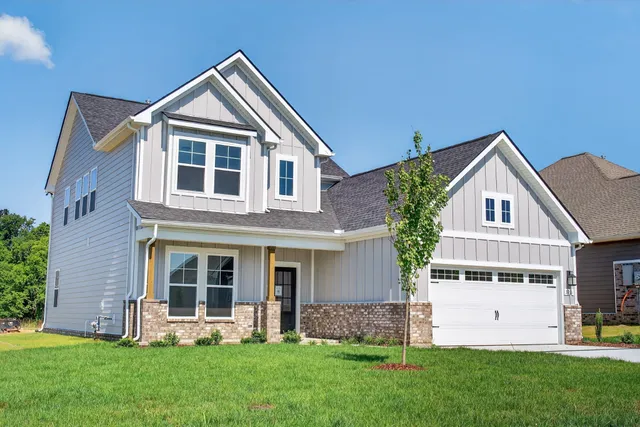 a front view of a house with a yard and porch