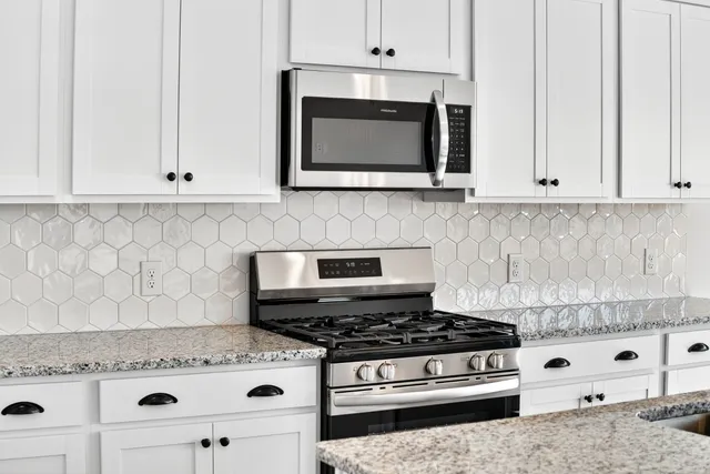 an empty room with windows and ceiling fan