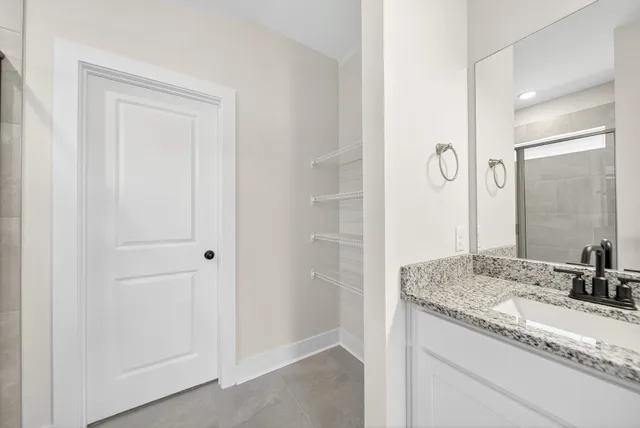 a bathroom with a double vanity sink a toilet and a mirror