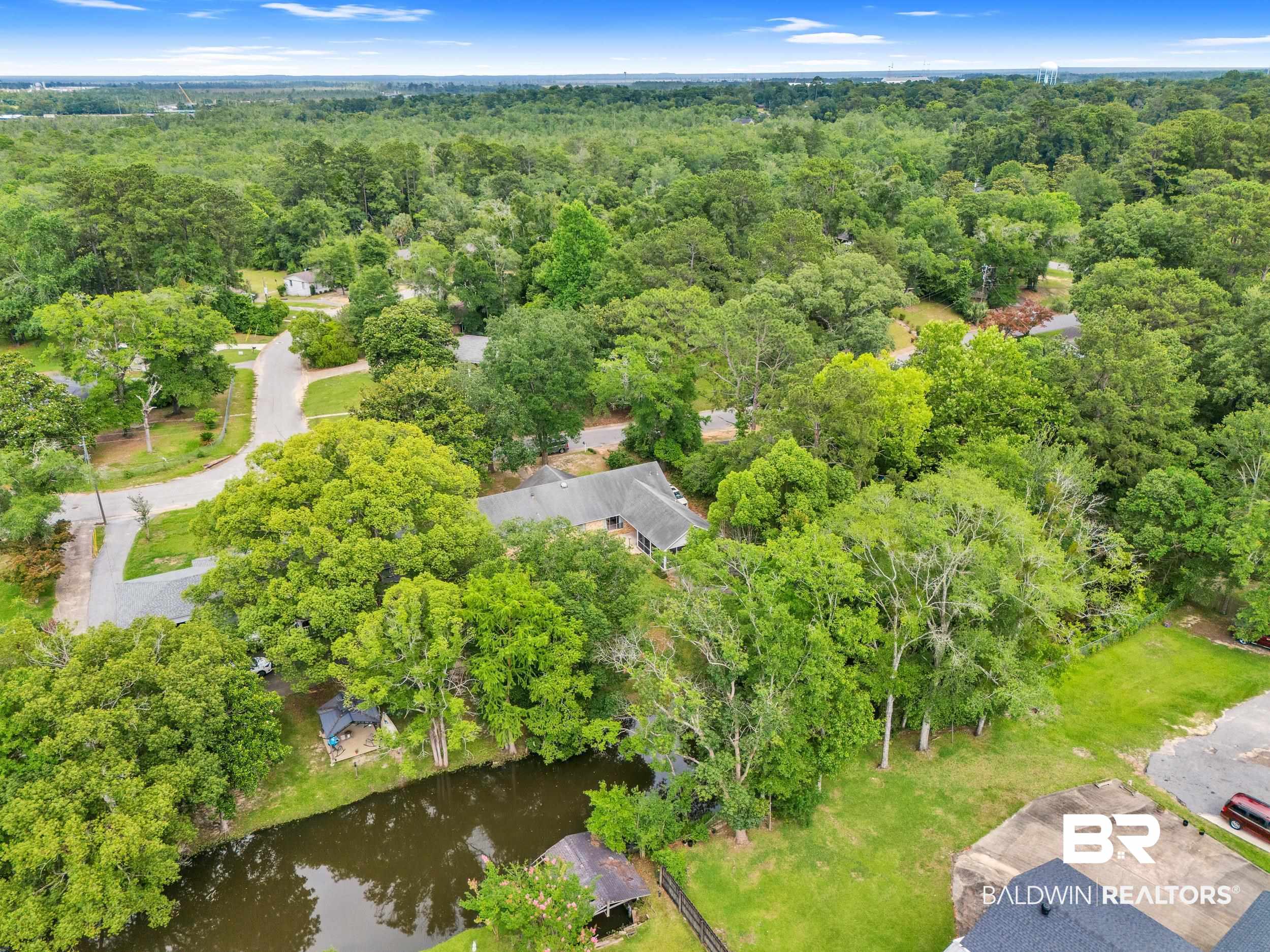 224 Cache Circle Mobile, AL 36611 - Photo 3 of 42 Aerial overview of property's location with a forest and a nearby body of water