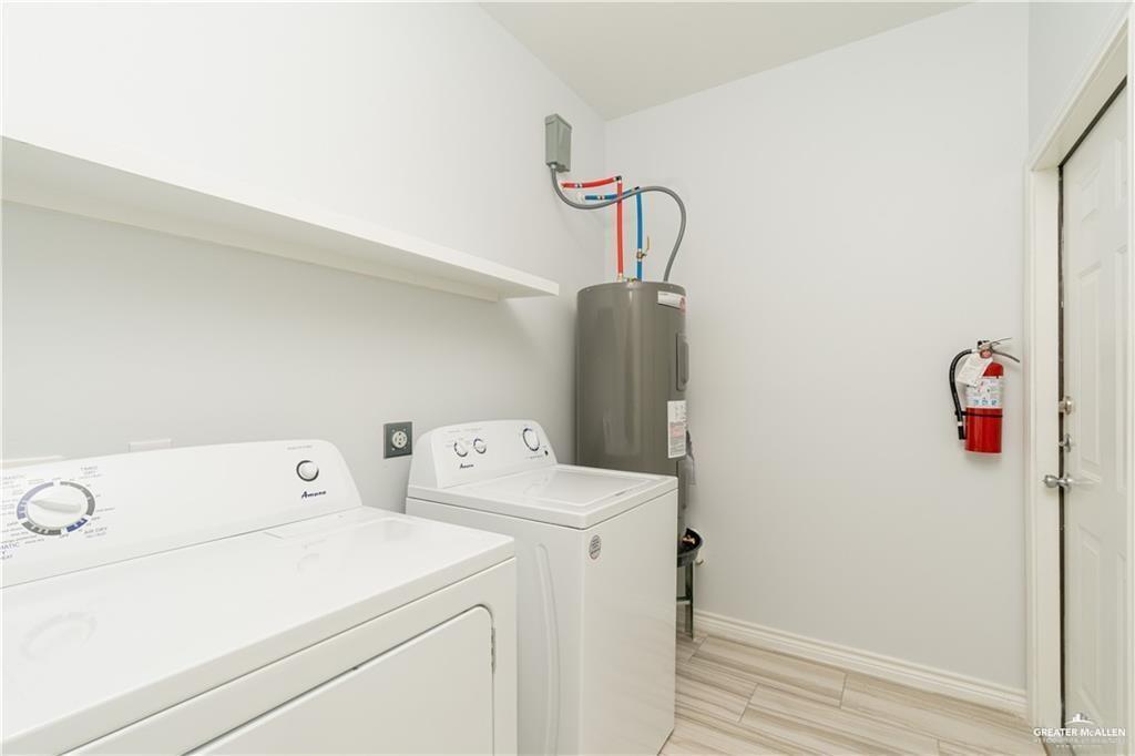 1306 Royola Street Mission, TX 78572 - Photo 14 of 16 a utility room with dryer and washer