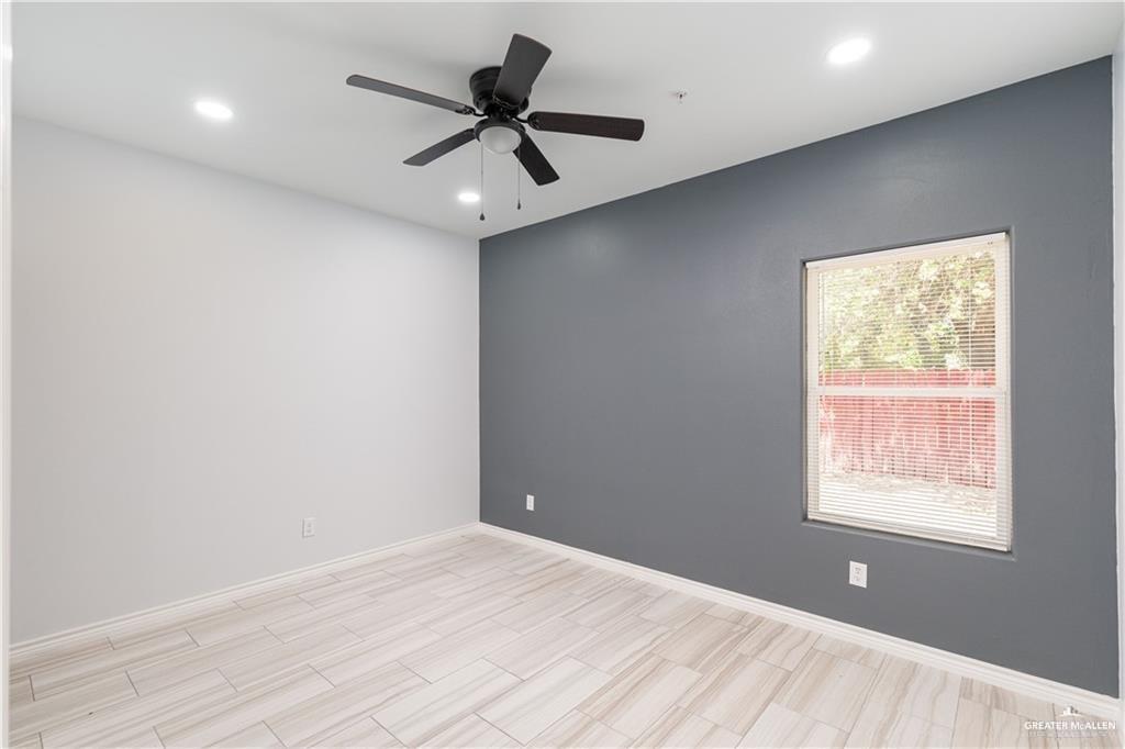1306 Royola Street Mission, TX 78572 - Photo 10 of 16 an empty room with a window and a ceiling fan
