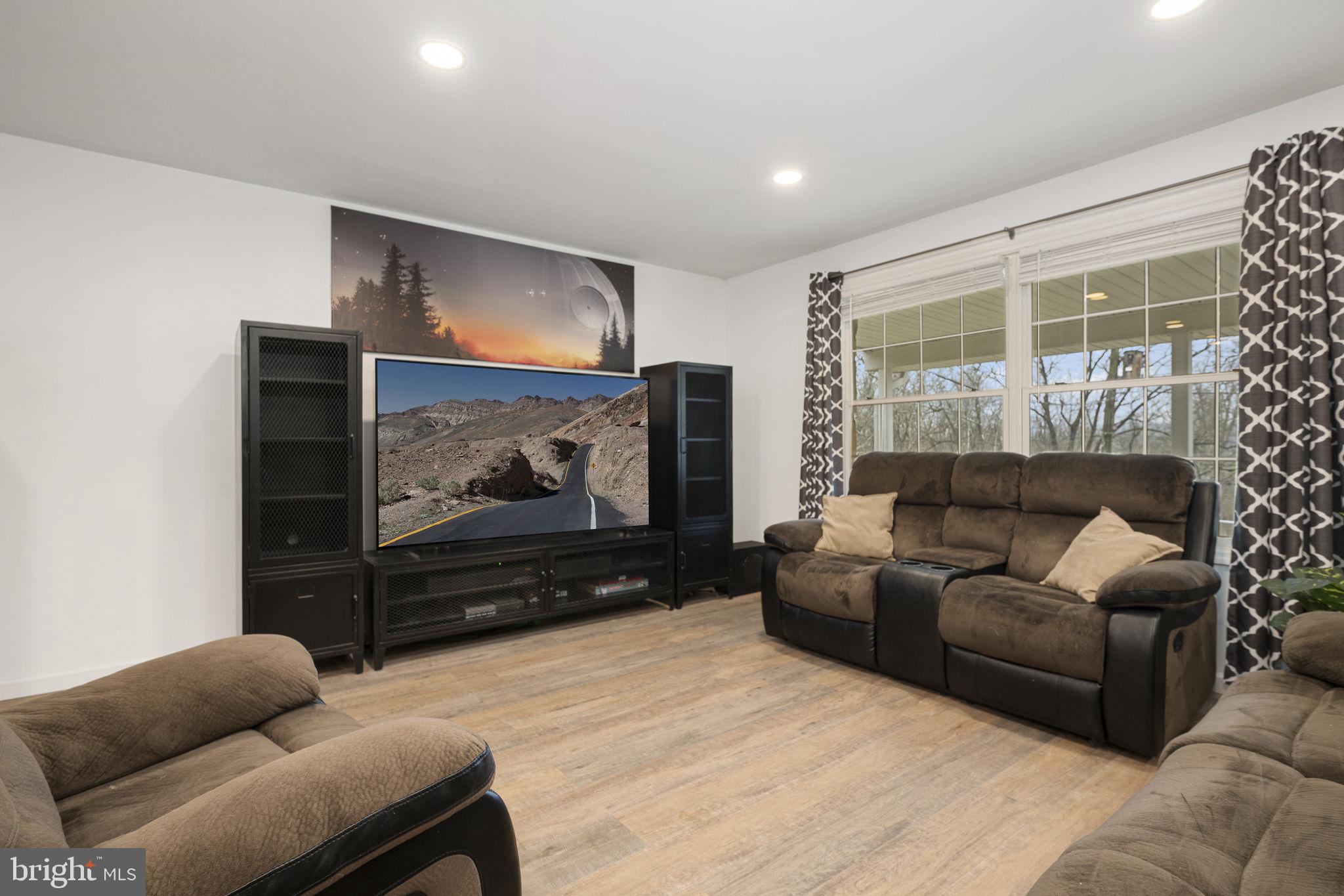 150 Modena Road Coatesville, PA 19320 - Photo 13 of 31 a living room with furniture a flat screen tv and a floor to ceiling window