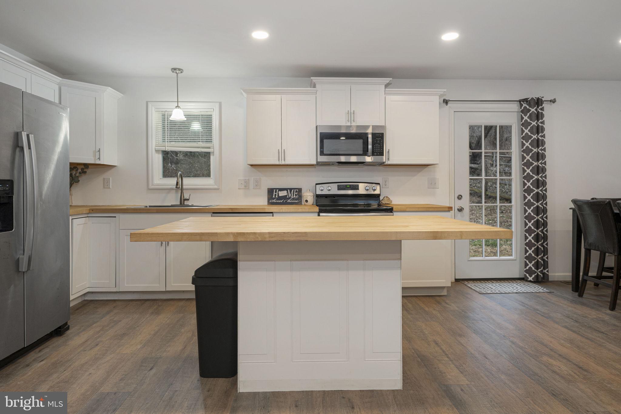 150 Modena Road Coatesville, PA 19320 - Photo 14 of 31 a kitchen with stainless steel appliances a sink cabinets and wooden floor