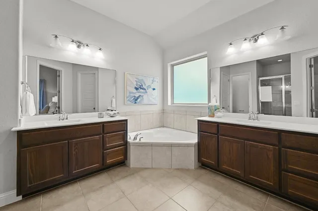 a spacious bathroom with a double vanity sink mirror and double