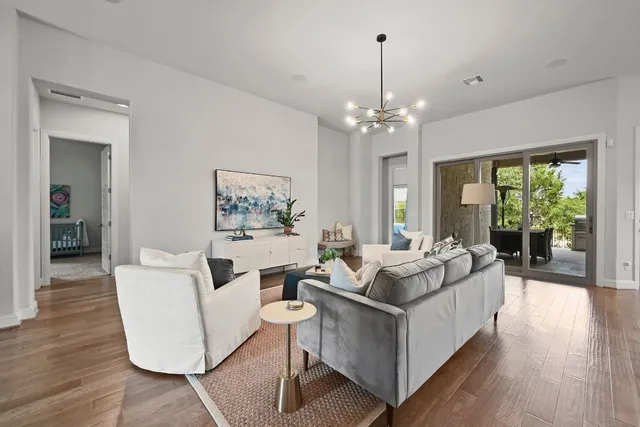 a living room with furniture and a chandelier