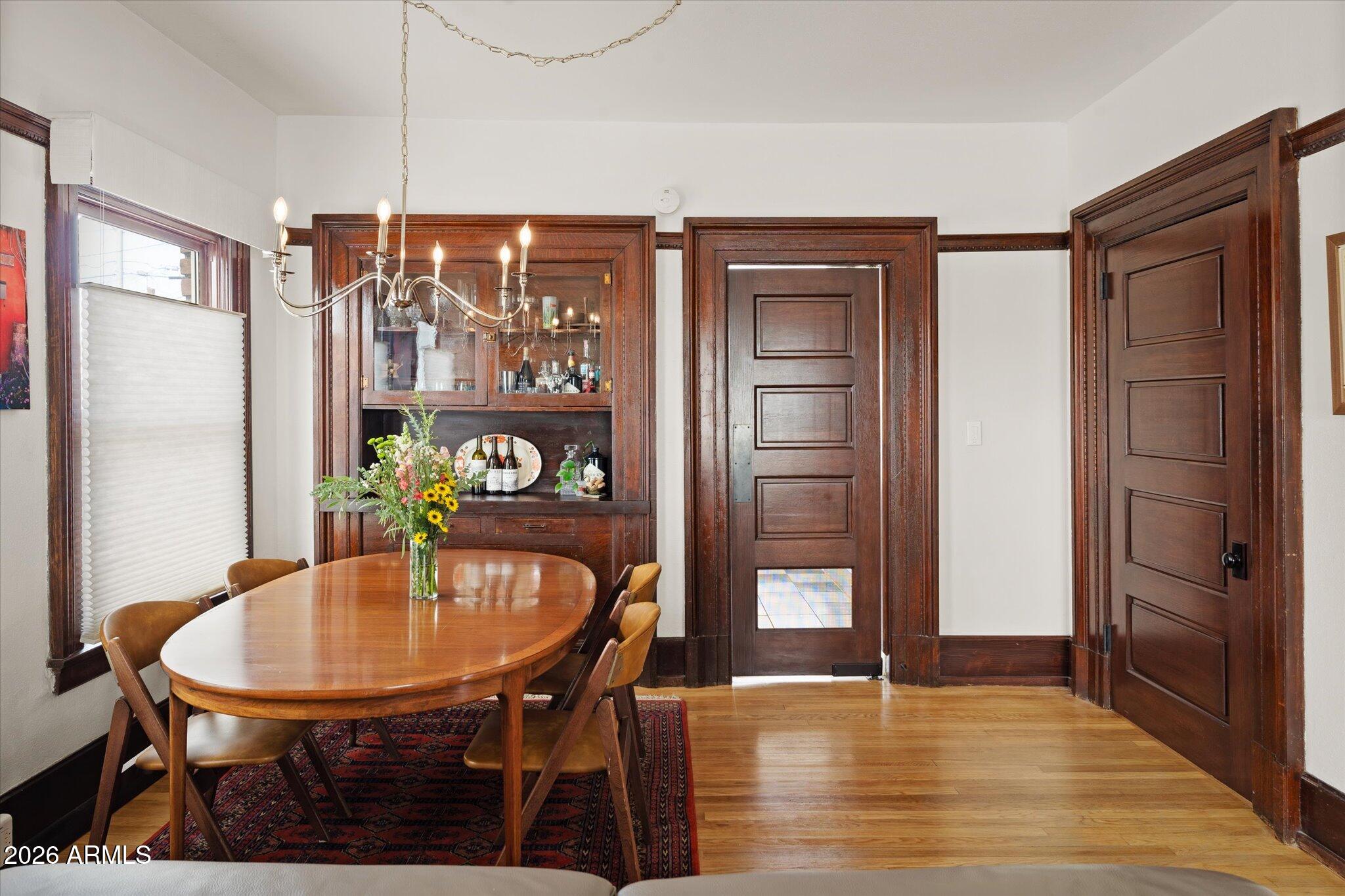 1348 East Fillmore Street Phoenix, AZ 85006 - Photo 12 of 41 a view of a dining room with furniture and wooden floor