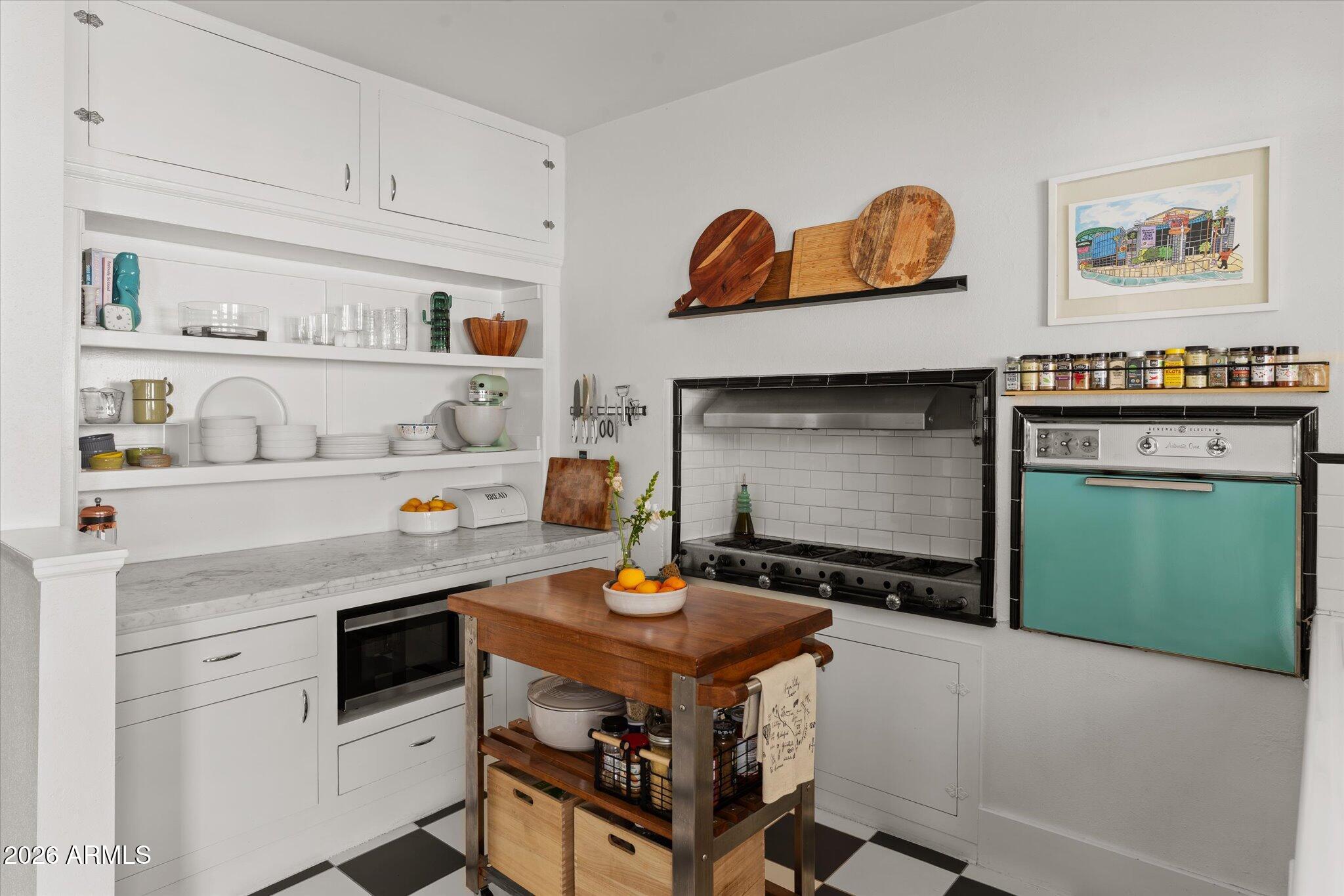1348 East Fillmore Street Phoenix, AZ 85006 - Photo 15 of 41 a kitchen with a stove and cabinets