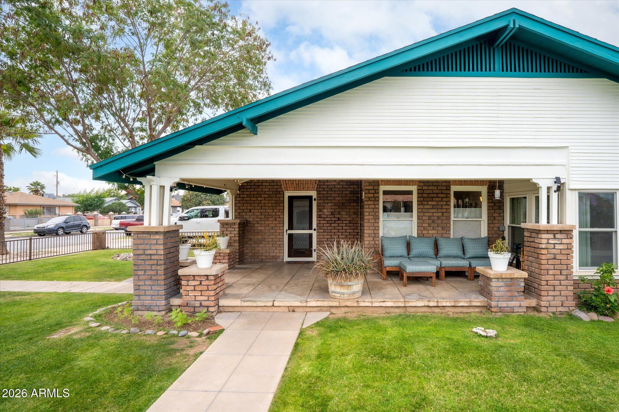 1348 East Fillmore Street Phoenix, AZ 85006 - Photo 2 of 41 a front view of a house with a garden and patio