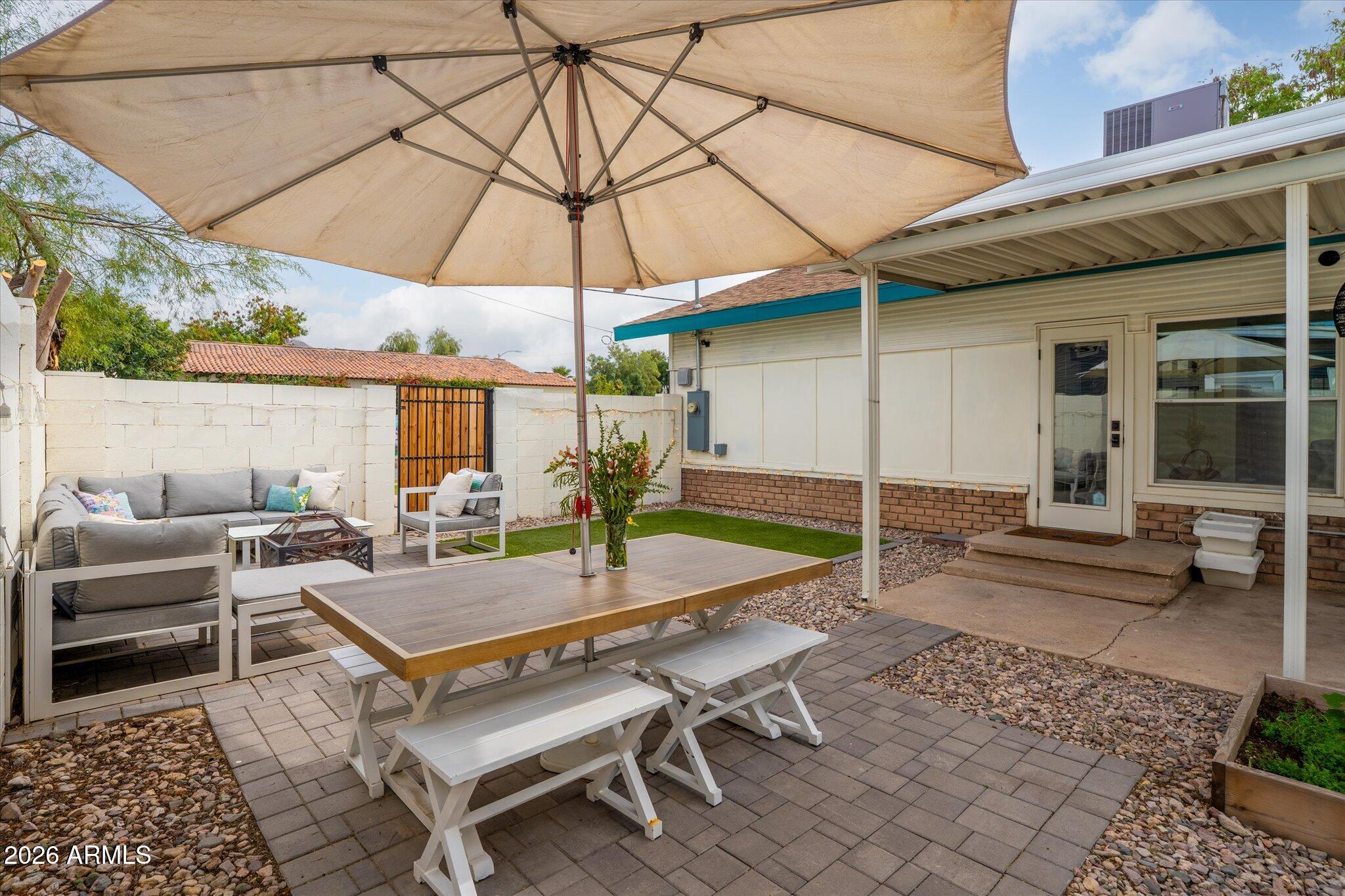 1348 East Fillmore Street Phoenix, AZ 85006 - Photo 34 of 41 a view of a patio with a table and chairs under an umbrella