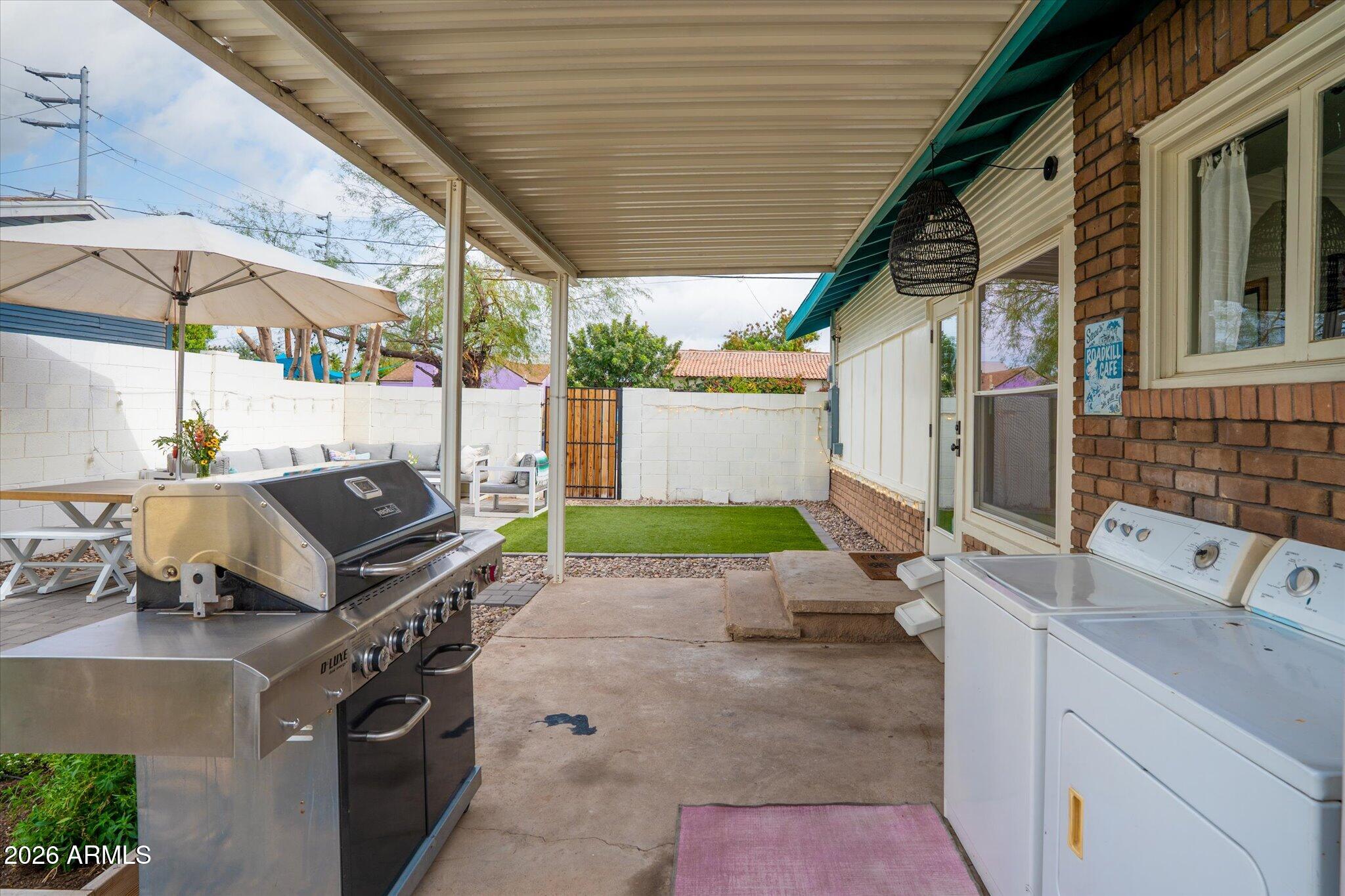 1348 East Fillmore Street Phoenix, AZ 85006 - Photo 37 of 41 deck with table and chairs under an umbrella