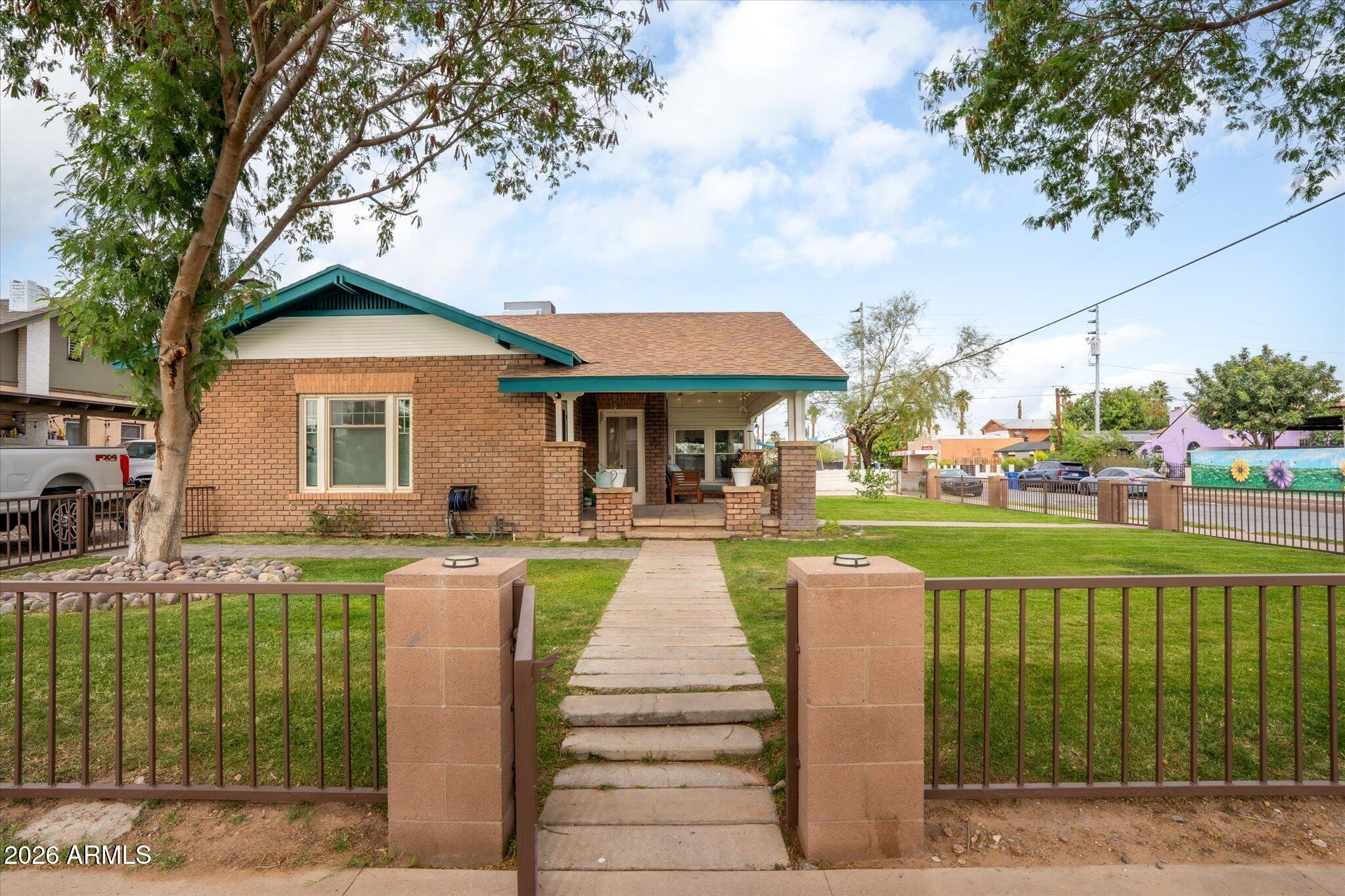 1348 East Fillmore Street Phoenix, AZ 85006 - Photo 38 of 41 a front view of a house with a yard table and chairs