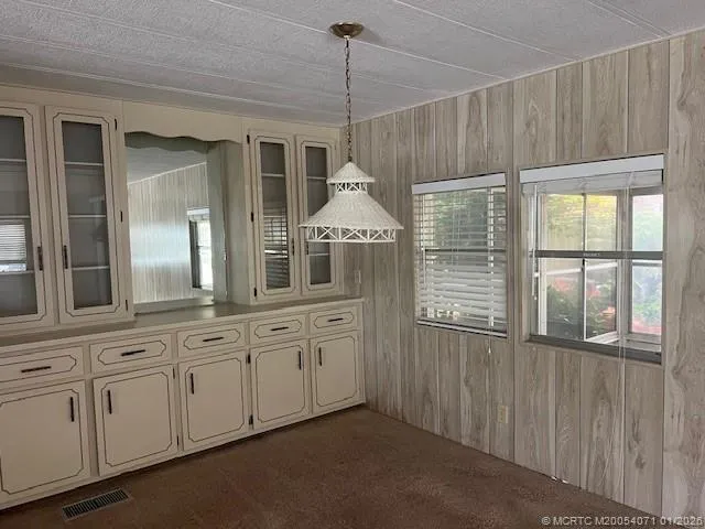 a kitchen with cabinets and window