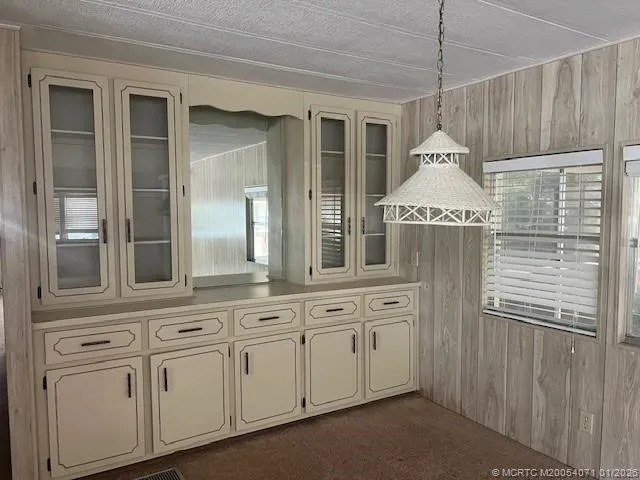 a kitchen with cabinets and a chandelier