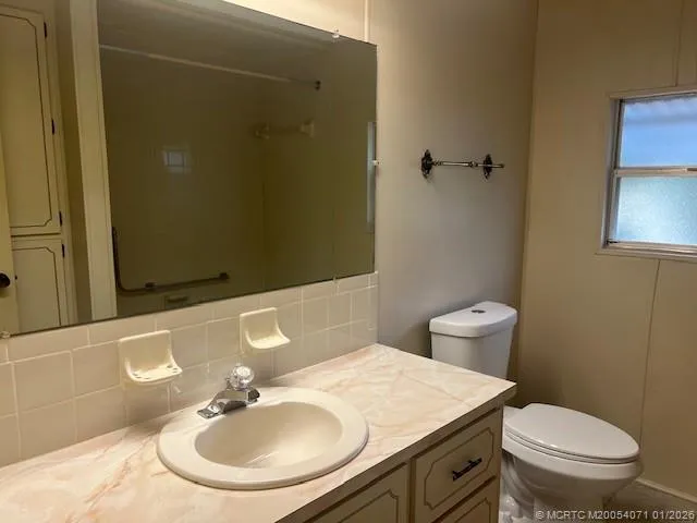 a close view of a utility room with dryer and washer