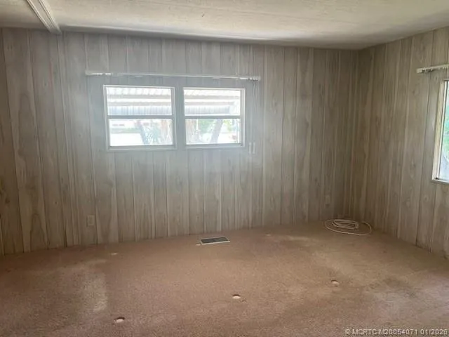 a white toilet sitting next to a small window