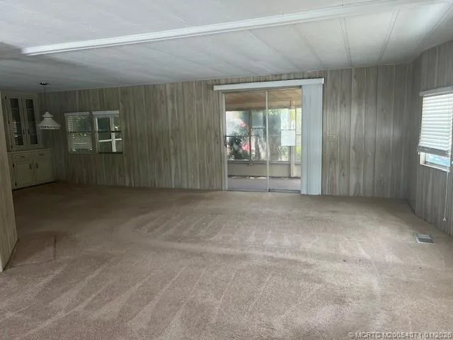 a view of a big room with windows and cabinet