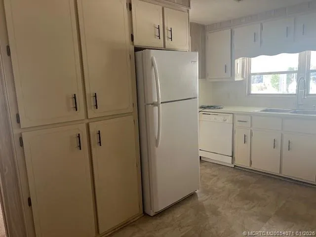 a white refrigerator freezer sitting in a kitchen