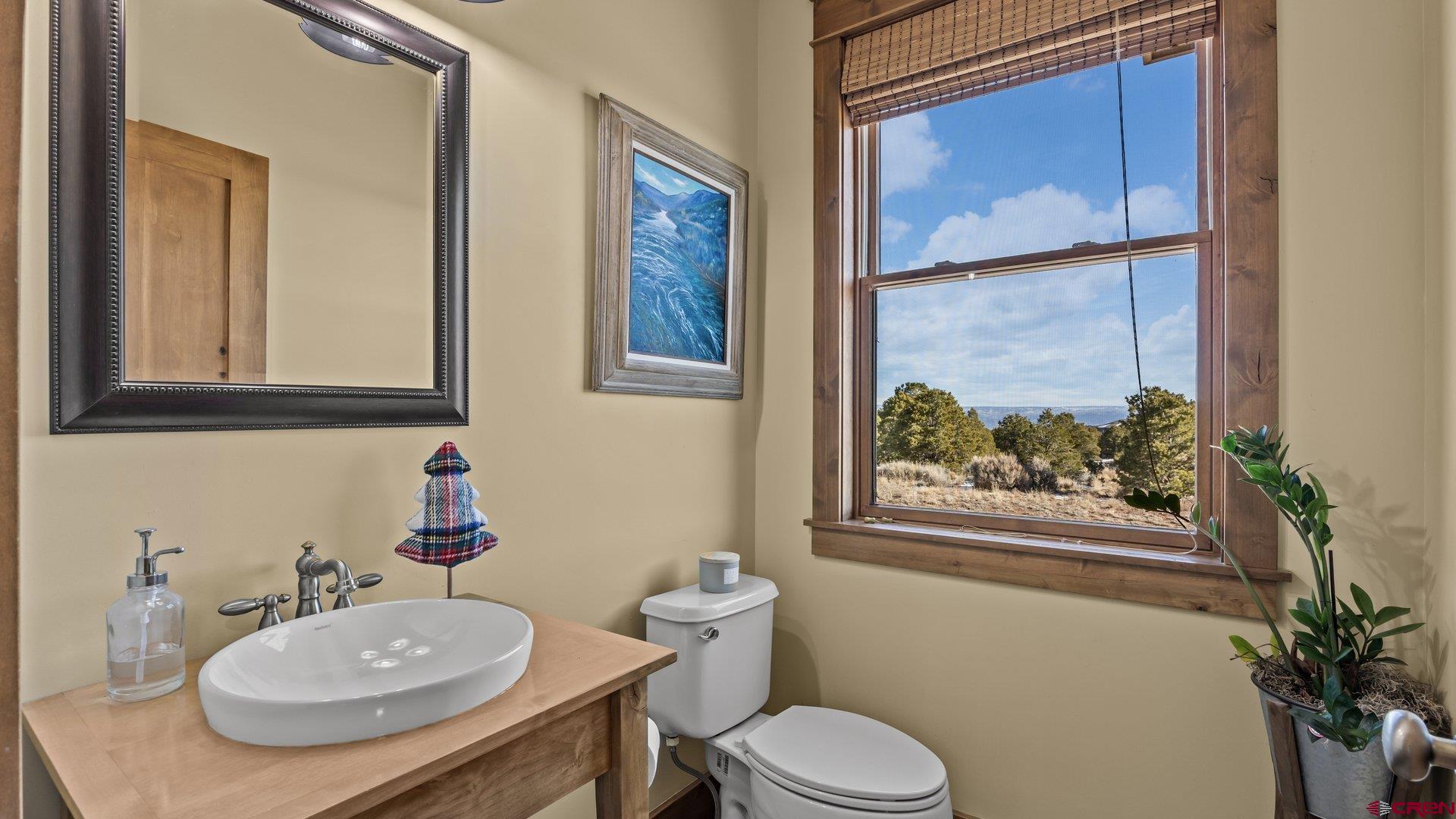 2601 South 21 1/2 Road Glade Park, CO 81523 - Photo 16 of 45 a bathroom with a toilet a sink and a mirror