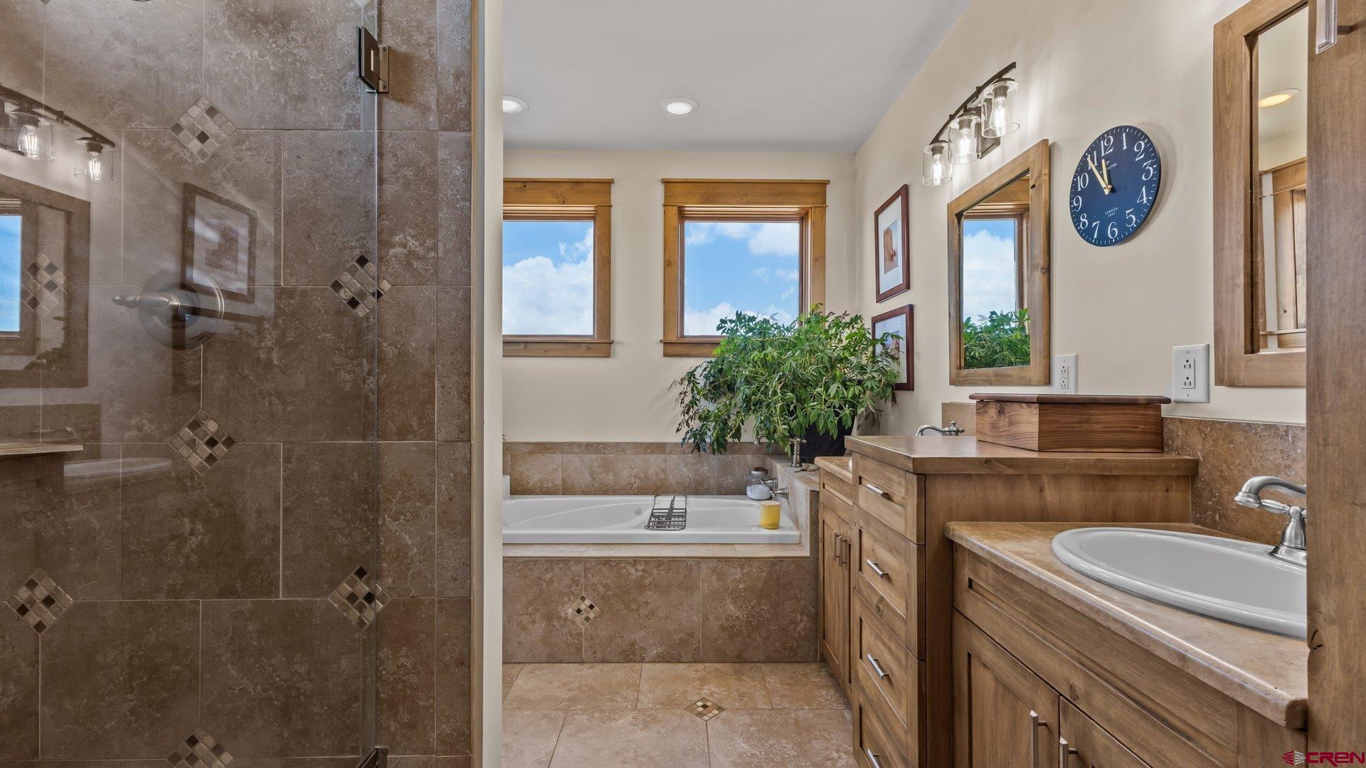 2601 South 21 1/2 Road Glade Park, CO 81523 - Photo 31 of 45 a bathroom with a tub a sink and a large mirror