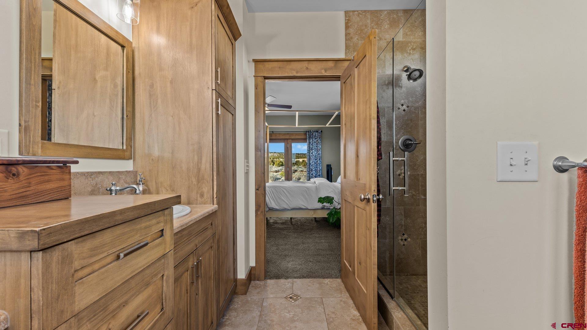 2601 South 21 1/2 Road Glade Park, CO 81523 - Photo 32 of 45 a en suite bathroom with a sink a mirror and a shower