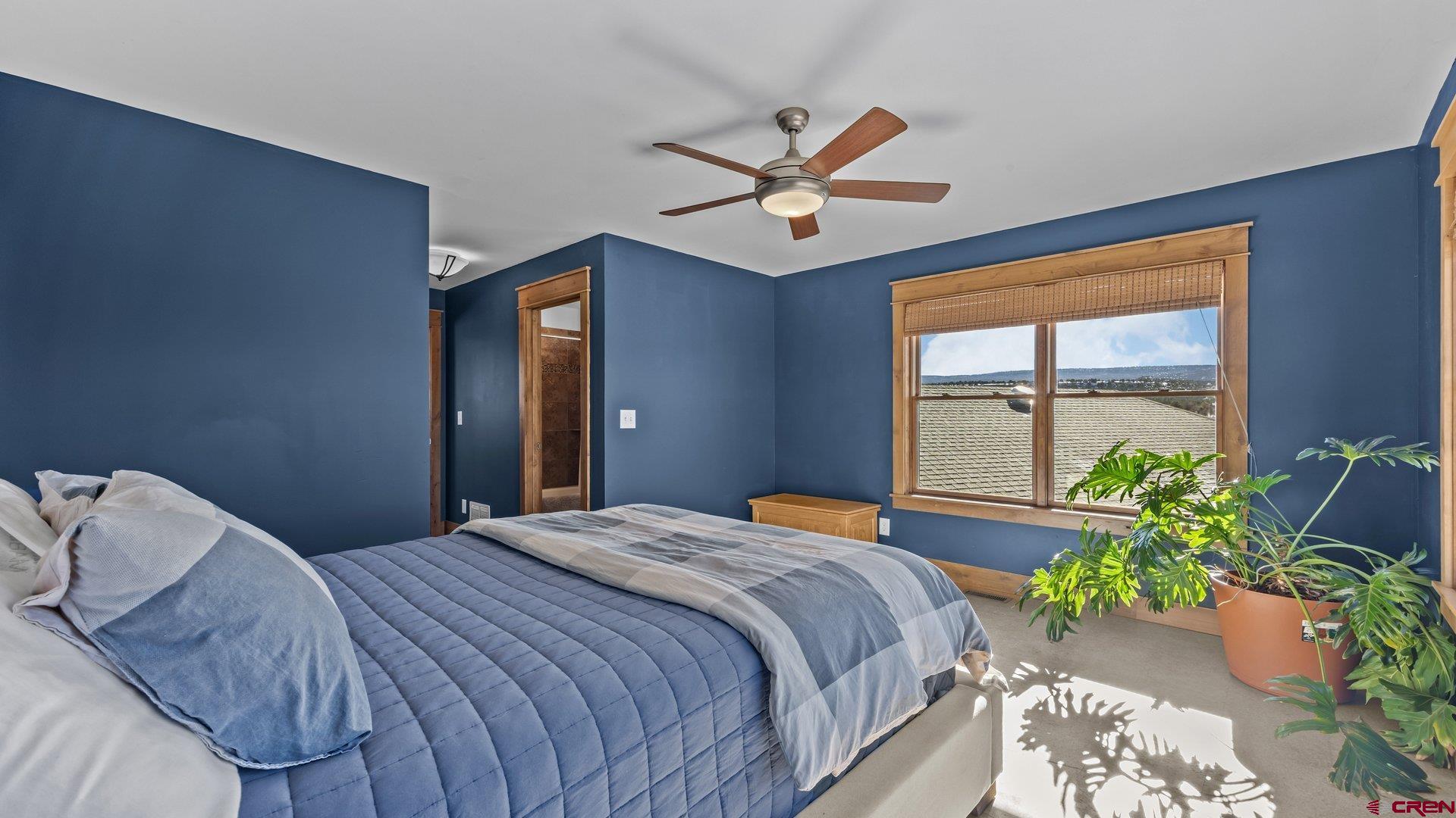 2601 South 21 1/2 Road Glade Park, CO 81523 - Photo 37 of 45 a bedroom with a bed and a potted plant