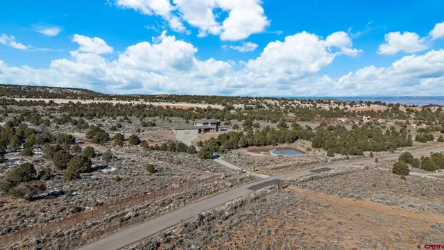 a living room with furniture kitchen view and a large window