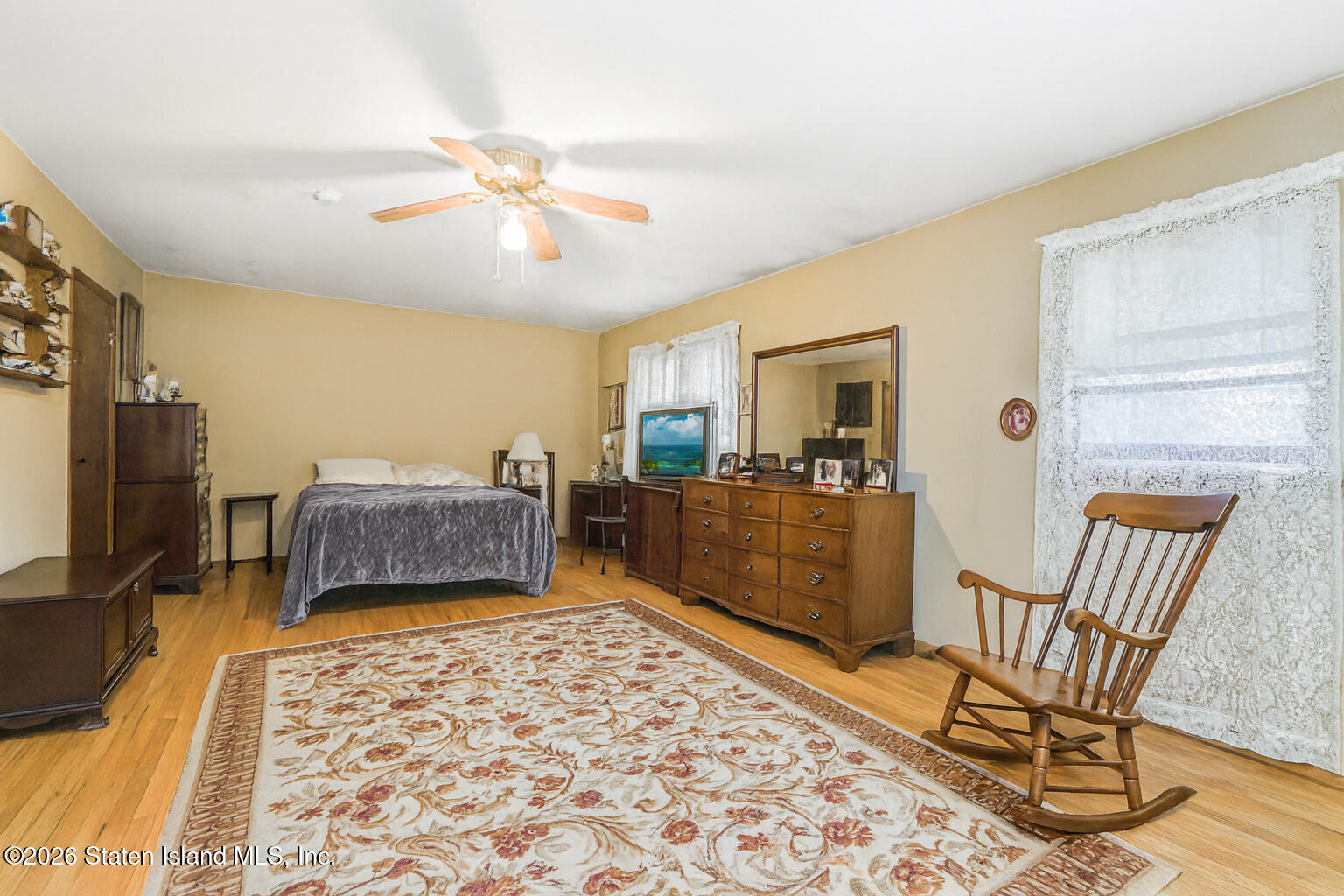 35 Shawnee Street Staten Island, NY 10310 - Photo 14 of 23 a living room with a couch and a dining table with wooden floor