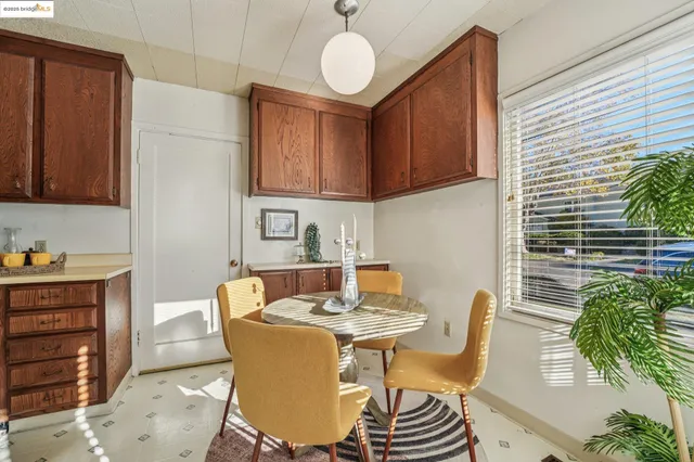 a view of a kitchen area with furniture and wooden floor