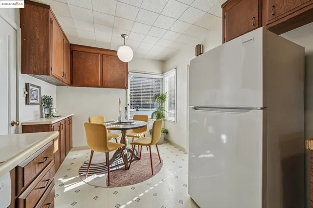 a kitchen with stainless steel appliances granite countertop a stove a refrigerator and a sink