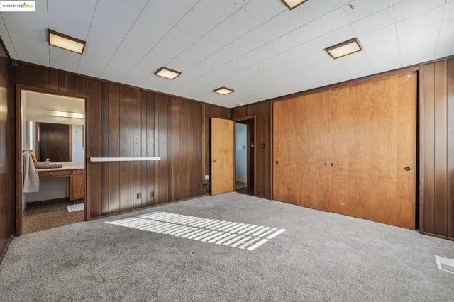 an empty room with large windows