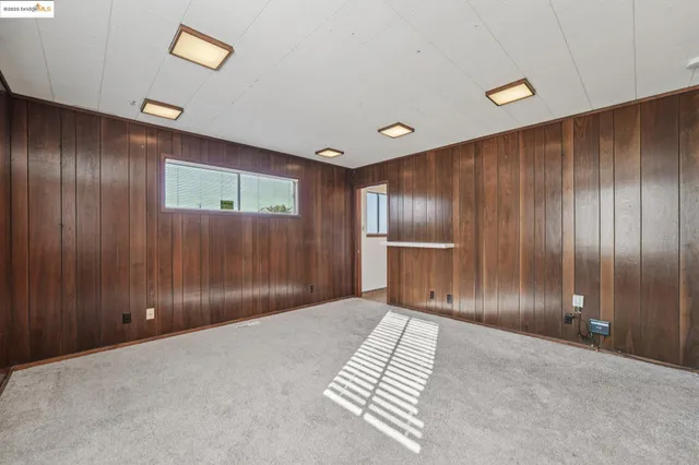 a view of a bedroom with wooden floor and stairs