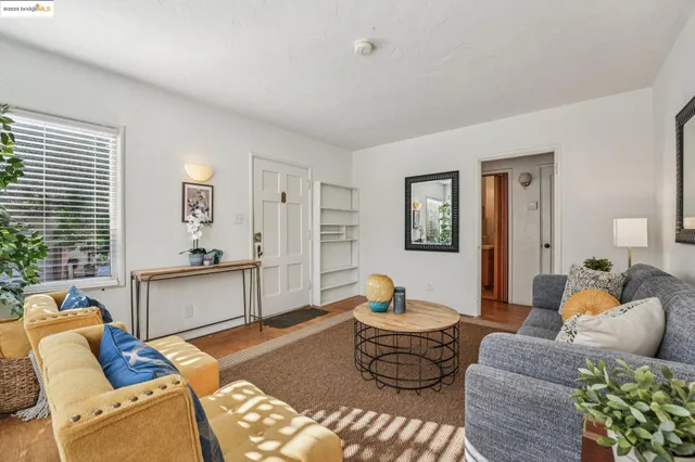 a living room with furniture flowerpot and window