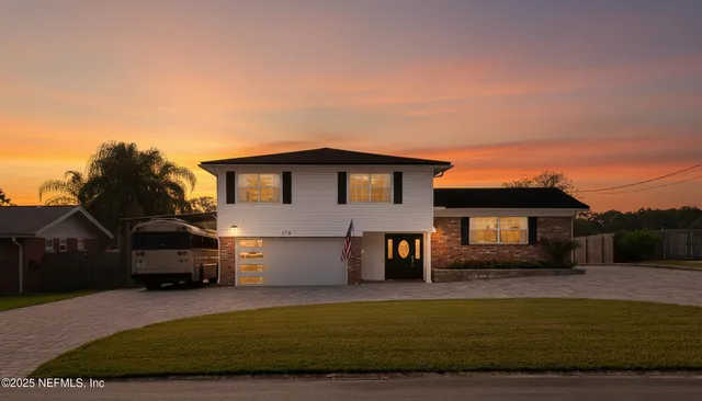 a front view of a house with a yard