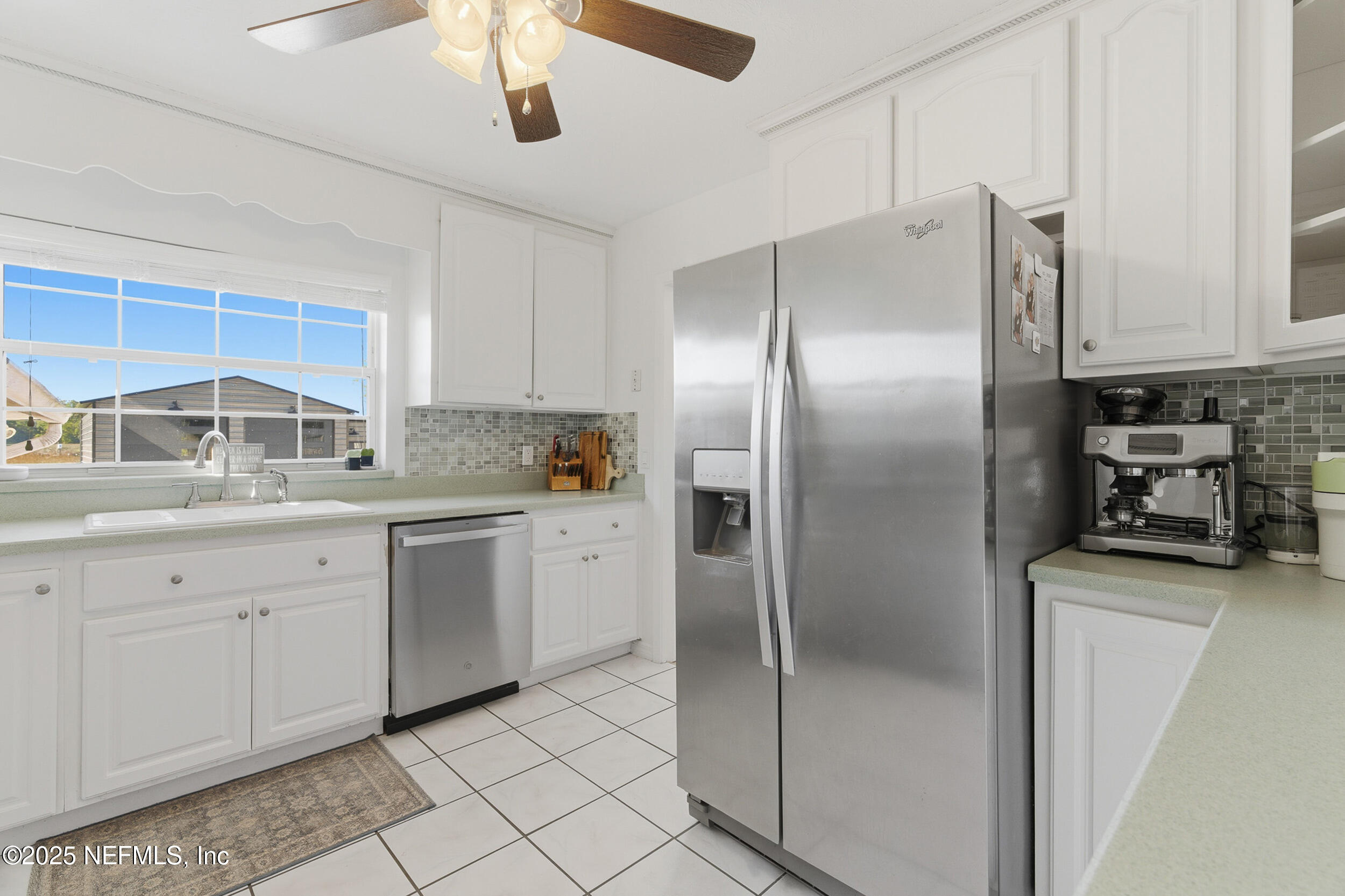 276 Baisden Road Jacksonville, FL 32218 - Photo 12 of 71 a kitchen with stainless steel appliances granite countertop a refrigerator a sink and white cabinets