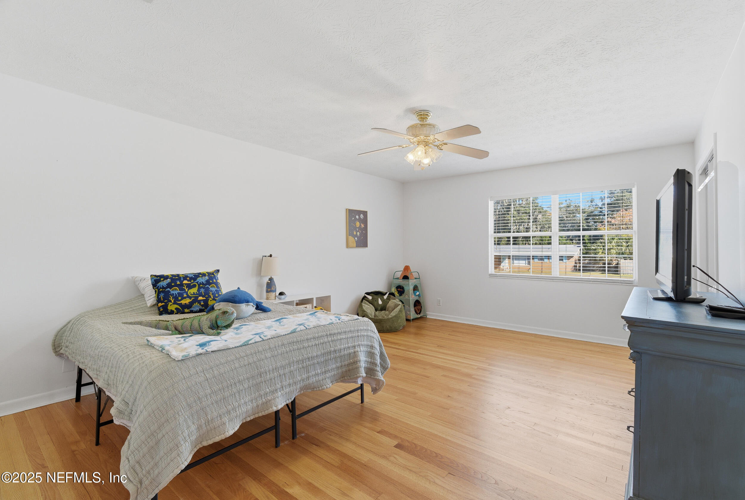 276 Baisden Road Jacksonville, FL 32218 - Photo 22 of 71 a bedroom with a bed table and a window