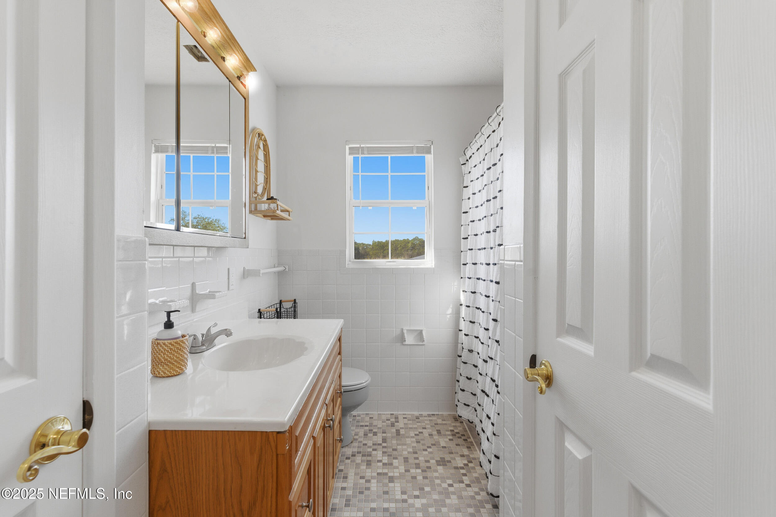 276 Baisden Road Jacksonville, FL 32218 - Photo 23 of 71 a bathroom with a sink a toilet and shower curtain