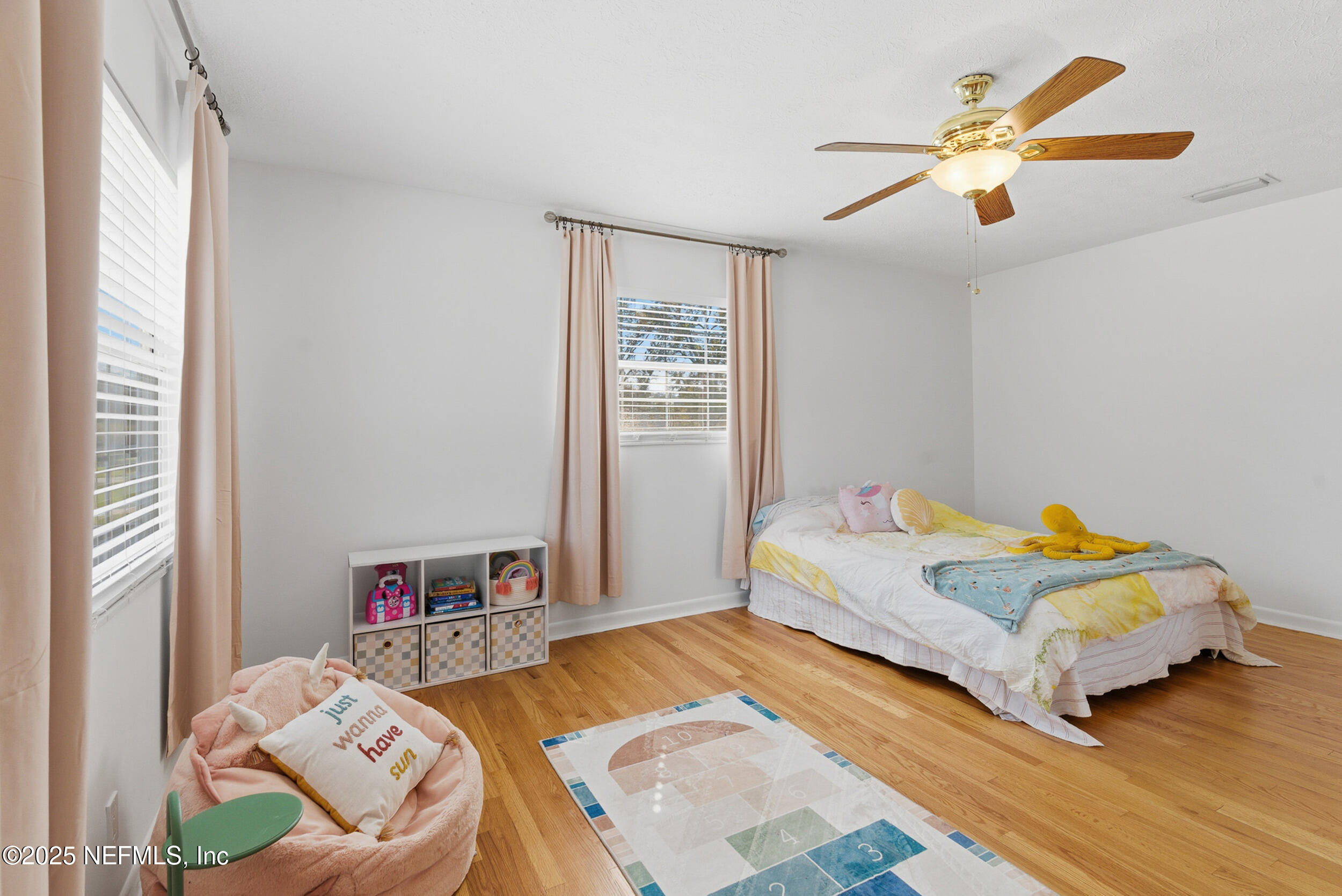 276 Baisden Road Jacksonville, FL 32218 - Photo 25 of 71 a bedroom with a bed and a chandelier