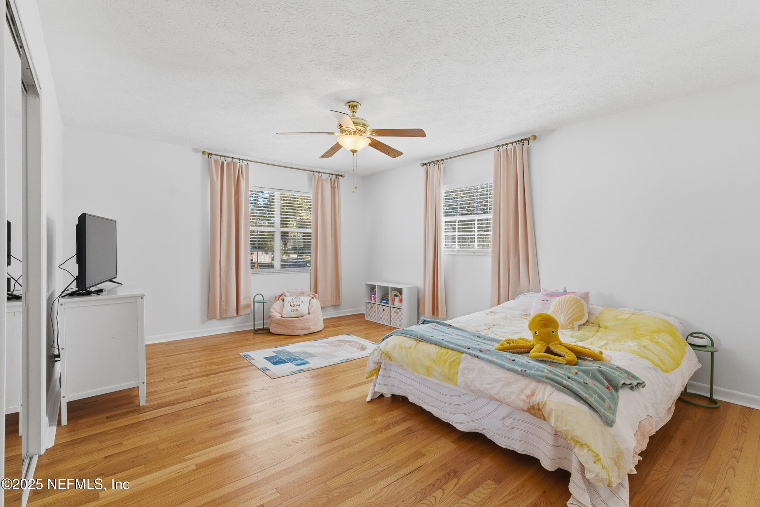 276 Baisden Road Jacksonville, FL 32218 - Photo 26 of 71 a bedroom with a bed and wooden floor