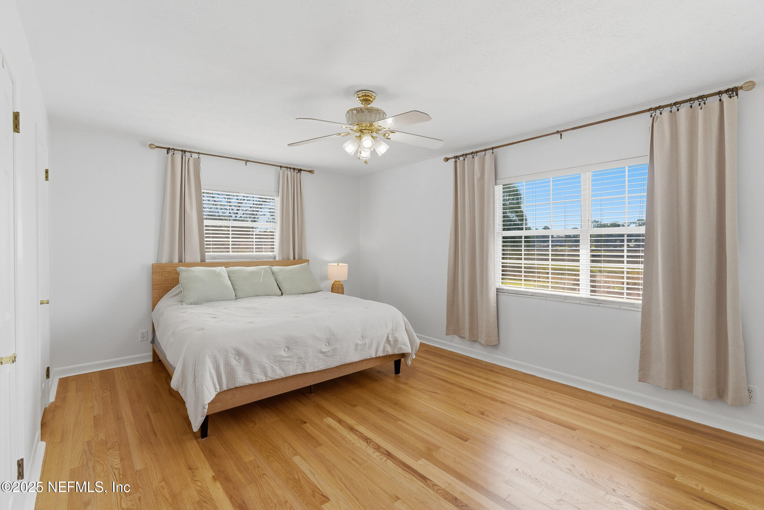 276 Baisden Road Jacksonville, FL 32218 - Photo 28 of 71 a bedroom with a bed and wooden floor