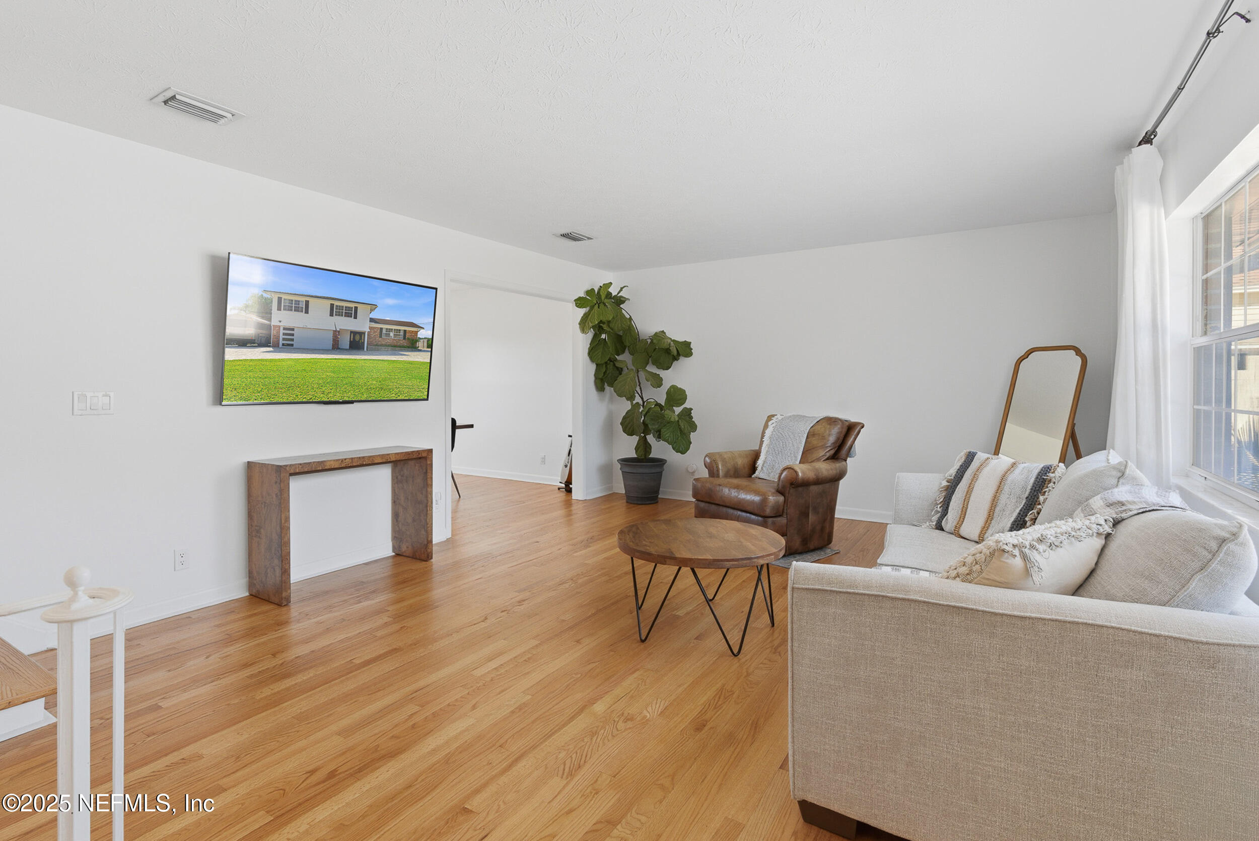 276 Baisden Road Jacksonville, FL 32218 - Photo 8 of 71 a living room with furniture and a wooden floor