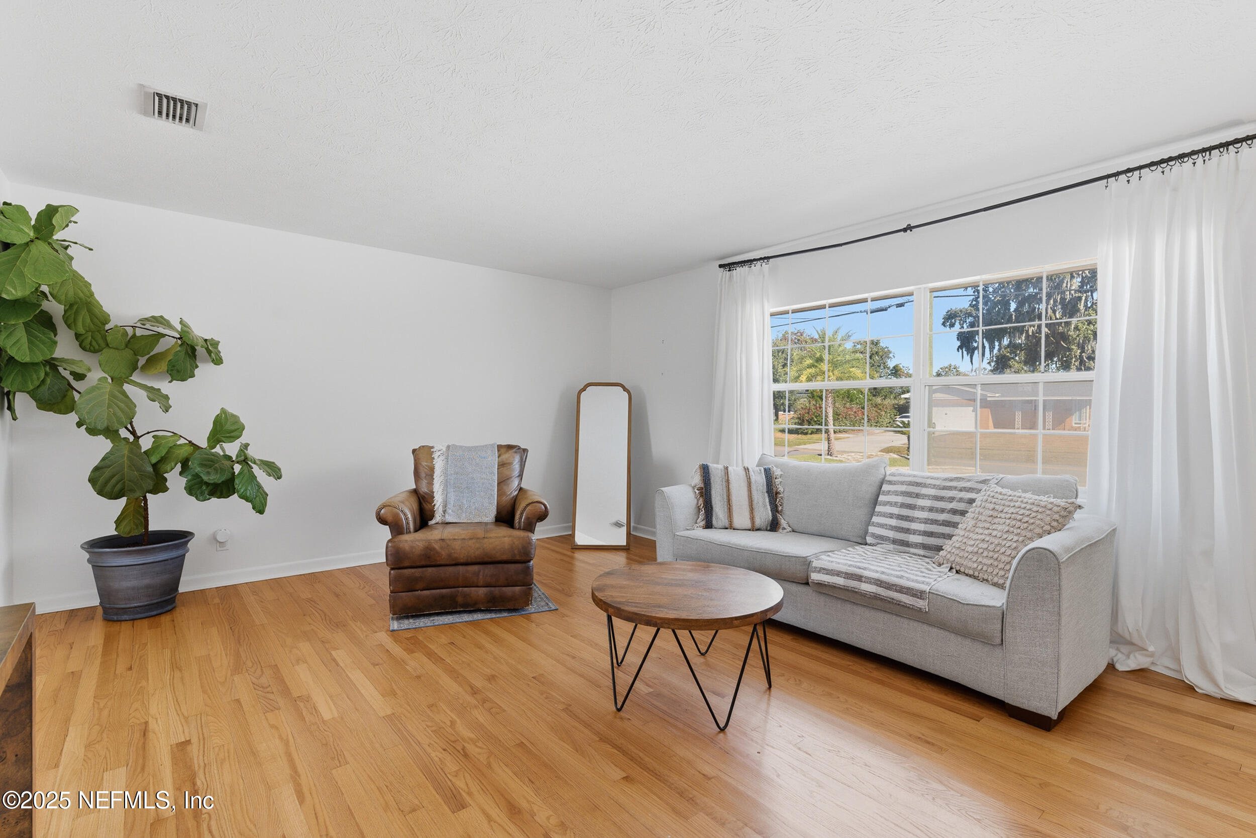 276 Baisden Road Jacksonville, FL 32218 - Photo 9 of 71 a living room with furniture and a potted plant