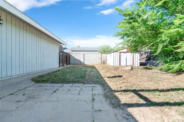 a view of a house with a backyard